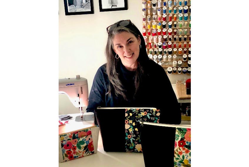 Lori Lewis at work in her home studio, crafting one-of-a-kind zippered bags and pouches.