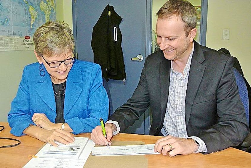 Cumberland Business Connector president Sue McIsaac and vice-president Mike Stack look over the organization’s action plan. The organization is closer to being functional and is presently in the market for a chief executive officer to lead it forward.
