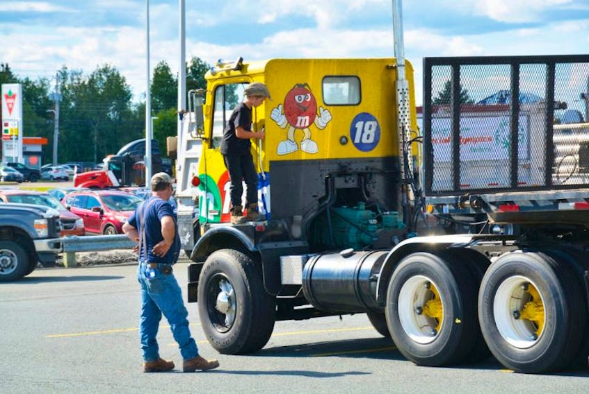 Dryden Schiefer climbed atop a cracker box truck, a style from the late ’50s, while his dad, Doug, watched during last year’s Bordertown Working Truck Show & Shine. The second annual event will take place in Amherst on Sept. 9-10.