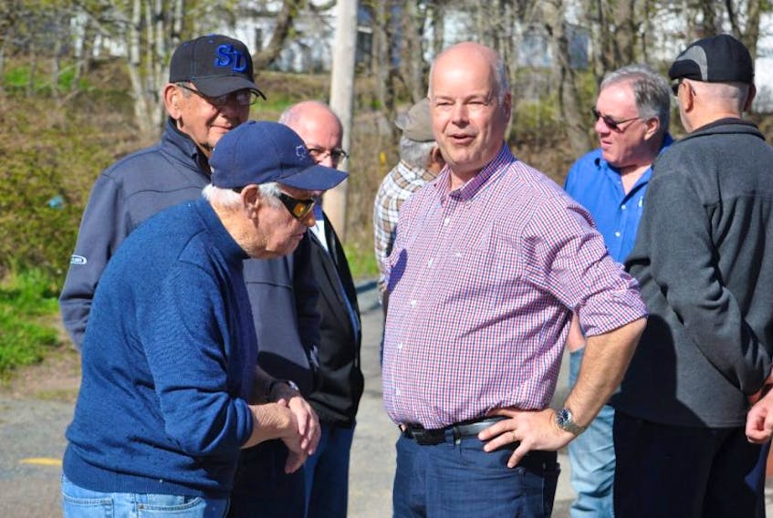 Former premier and longtime cabinet minister Roger Bacon (left) was among the well wishers greeted by Progressive Conservative leader and Cumberland South candidate Jamie Baillie, who held the official opening of his campaign office in Springhill on Monday.