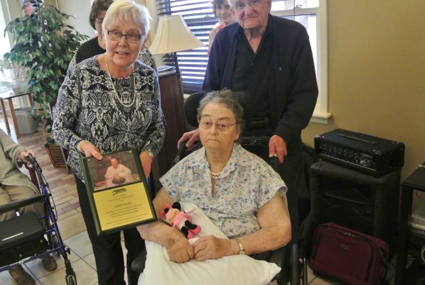 (From left) Bridge Adults Services board member Evelyn Bradford honoured long time volunteer Terry McGee this month, alongside her husband Jack. 
