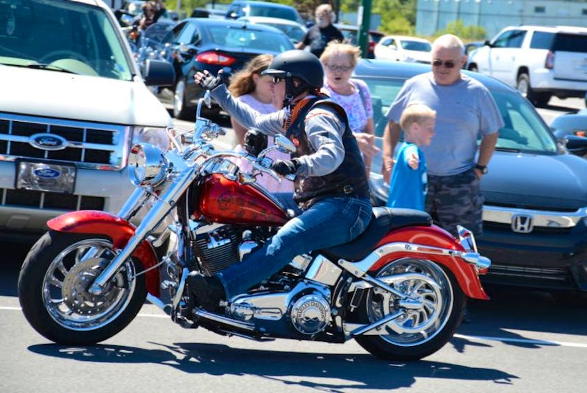 Six-year-old Liam Mallery waved and gave high-fives to bikers as they left Amherst Town Square Mall Sunday afternoon. Liam attended the Bordertown Biker Bash every day with his 10-year-old sister Olivia and his grandparents Bill and Lillian Mallery.