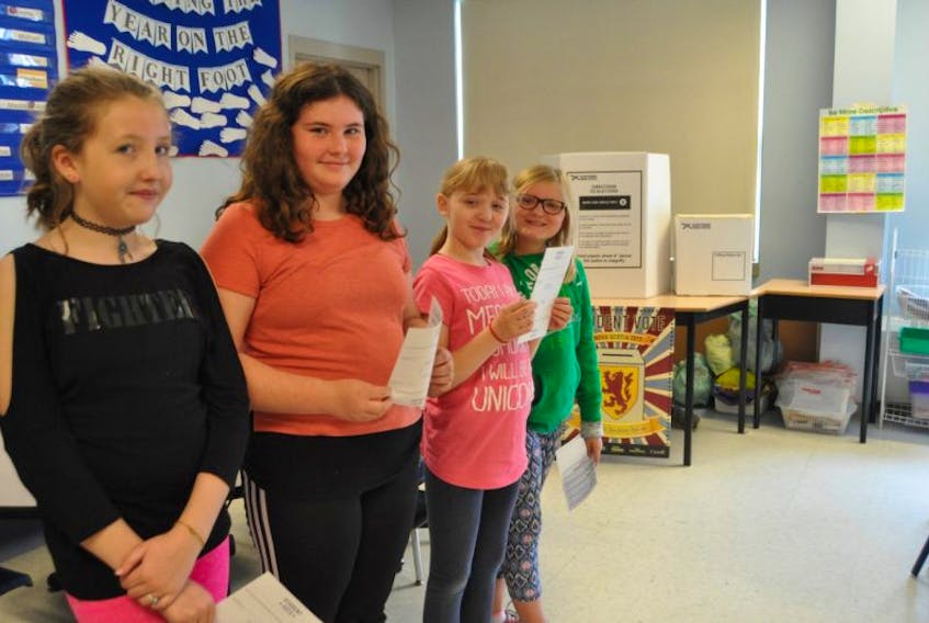 Grade 5/6 students at Spring Street Academy were among five classes taking part in Student Vote on Monday. Lining up to cast their ballots were (from left) Emma Allen, Katie Atkinson, Lily Gilbert and Declan Forysthe.