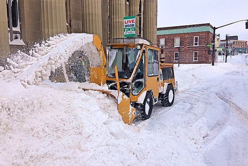 A public works blower clears snow from the front of Amherst's town hall building early Friday. Approximately 25 centimetres of snow fell on the area overnight. Another storm is forecast for Sunday night into Monday.