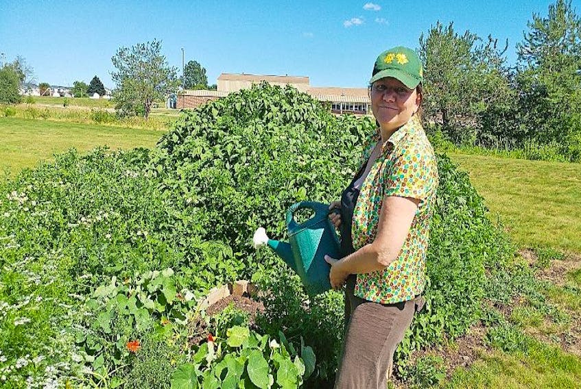 Su Morin, Cumberland Community Food Coordinator for Ecology Action Centre, waters the Amherst community garden. She believes that more could be done to increase local production.