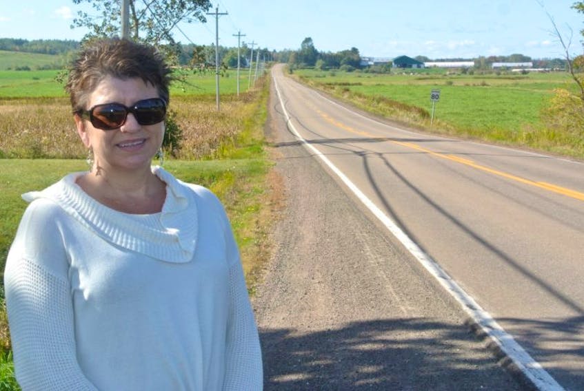 Glenna O’Quinn stands beside Highway 302 near Amherst. She’s concerned with the speed and unsafe driving by some vehicles turning onto the highway from Highway 2 in Upper Nappan. 