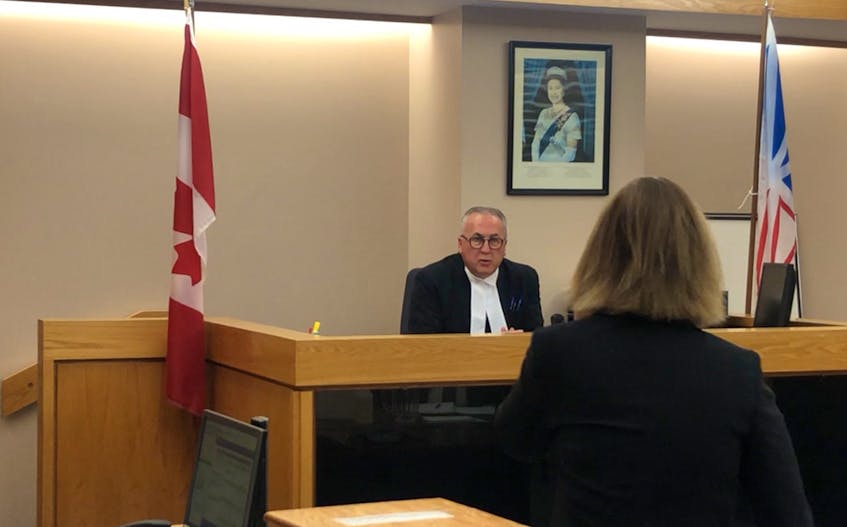 Provincial Court Judge James Walsh speaks to prosecutor Nicole Hurley from the bench before delivering his verdict in the case of a 28-year-old man charged with child luring. Walsh convicted the man on all six offences with which he was charged.