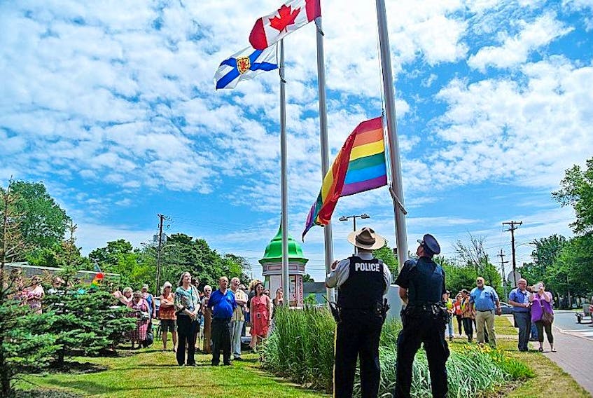 Members of the RCMP and the Amherst Police Department raise the Pride flag during a ceremony in Amherst last summer. The town is hosting its first ever Pride parade on Saturday, June 3 starting at 2 p.m. at Victoria Square.