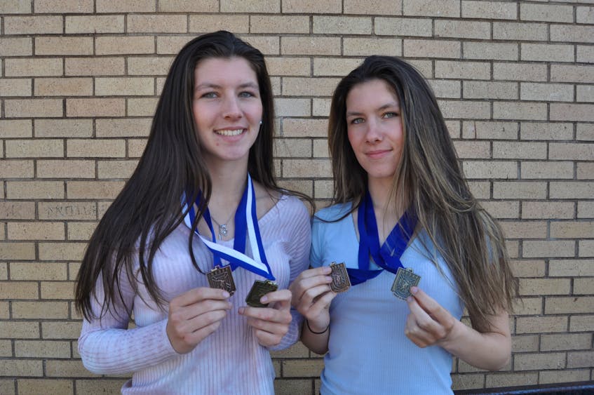 Gabby (left) and Denver Fraser of Advocate wrapped up their exceptional high school track and field careers with multiple medals at the provincial championships in Sydney over the weekend, including a new provincial record by Gabby in triple jump.
