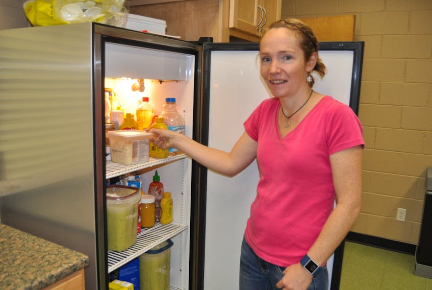 Alison Lair checks the fridge at the Cumberland YMCA in Amherst. The facility will be starting a Community Kitchen program on Wednesdays, starting on Jan. 10, 2018.