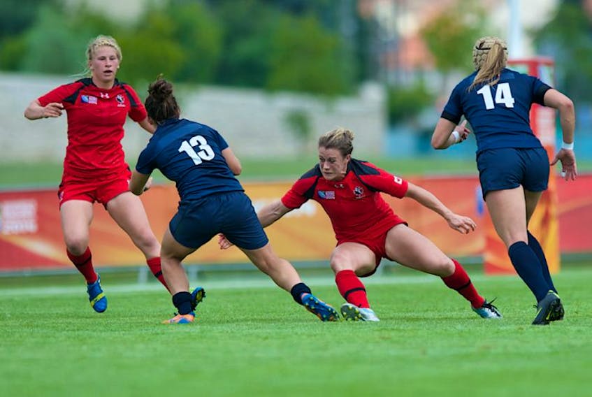 Former Acadia Axewomen Andrea Burk, second from right, is competing with Canada's senior women's rugby team.