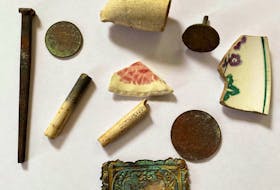 Some items found during a landscaping project in Lingan. Old pottery, clay pipes, square-head nails and an 1856 Nova Scotia one cent token. The item at the bottom with the ship is a mystery. Anyone have any ideas? CONTRIBUTED