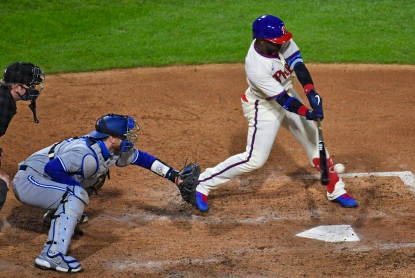 Phillies centre fielder Andrew McCutchen (right) hits an RBI single during the fifth inning against the Blue Jays at Citizens Bank Park in Philadelphia, Saturday, Sept. 19, 2020.