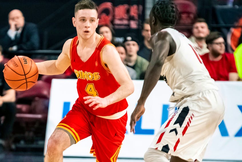Antigonish native Andrew Milner of the Calgary Dinos makes a move on Munis Tutu of the Carleton Ravens during the 2019 U Sports Final 8 men’s basketball championships at Scotiabank Centre in Halifax. Mona Ghiz