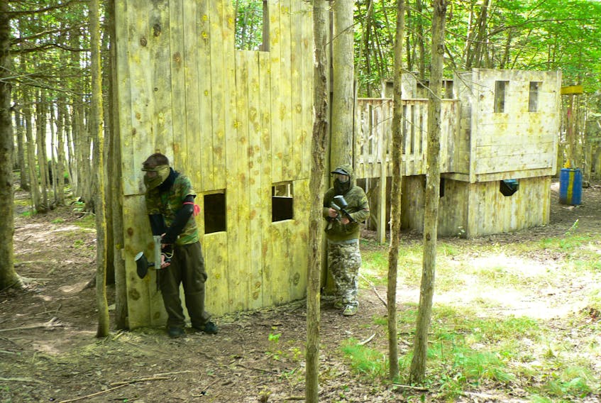Paintball players on the defensive plot out their next move at Storm Warning’s outdoor facility in Kings County. - Contributed