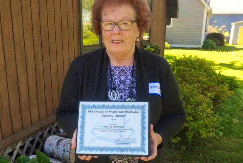 <p>Annie Lee MacDonald, president of Canadian Hard of Hearing Association P.E.I. Chapter, displays the Access P.E.I. Award present to her by the P.E.I. Council of People with Disabilities during their recent meeting in Summerside.</p>