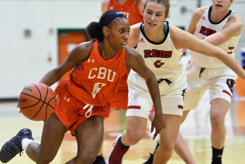 Cape Breton University Capers player Monique Calliste, far left, a second team all-star in Atlantic University Sport this season, and her CBU teammates will take on the University of New Brunswick in playoff action today in Halifax. She is seen here in action against the Varsity Reds at the Sullivan Field House this past season. CONTRIBUTED/VAUGHAN MERCHANT, CBU