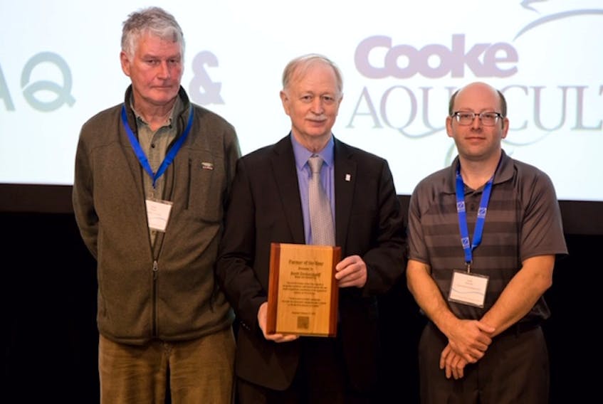 Englishtown resident Robin Stuart, left, was recently awarded a lifetime achievement award for his 47 years of contributions to the aquaculture industry in Nova Scotia. Making the presentation was Minister of Fisheries and Aquaculture Keith Colwell, centre, and Scott Sampson, president of the Aquaculture Association of Nova Scotia, which sponsored the award, and director of aquaculture operations with Louisbourg Seafoods. CONTRIBUTED