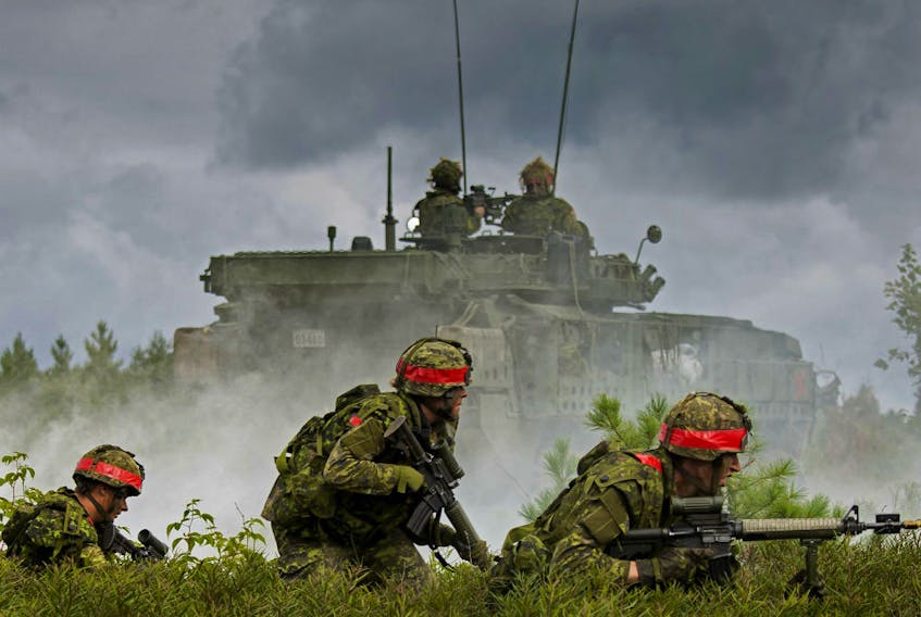 Simulated opposing forces attack a defensive position occupied by members of the Canadian Army Reserve, 4th Canadian Division, during Exercise STALWART GUARDIAN on August 26, 2015 at Garrison Petawawa, Ontario.