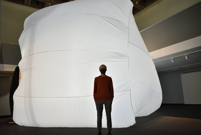 Evan Furness, visual arts educator at the Confederation Centre Art Gallery is dwarfed by a limited run exhibit of Quebecois artist Alexis Bellavance's Compression-depression, an inflatable sculpture originally meant to be part of Art in the Open. Taking up most of the Sobey Gallery, the exhibit is open for viewing until Oct. 4.