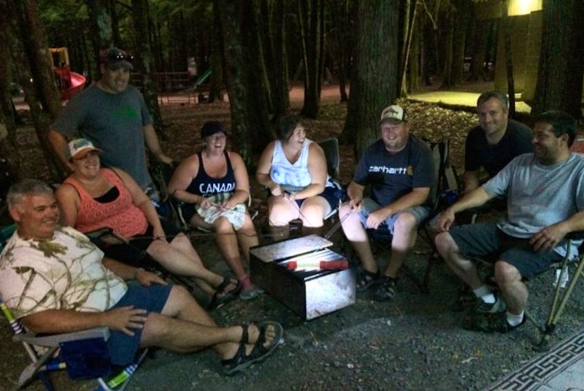 Campers from Yarmouth gather round a fireless fire pit at Dave and Jessica DeMille’s campsite in Keji.