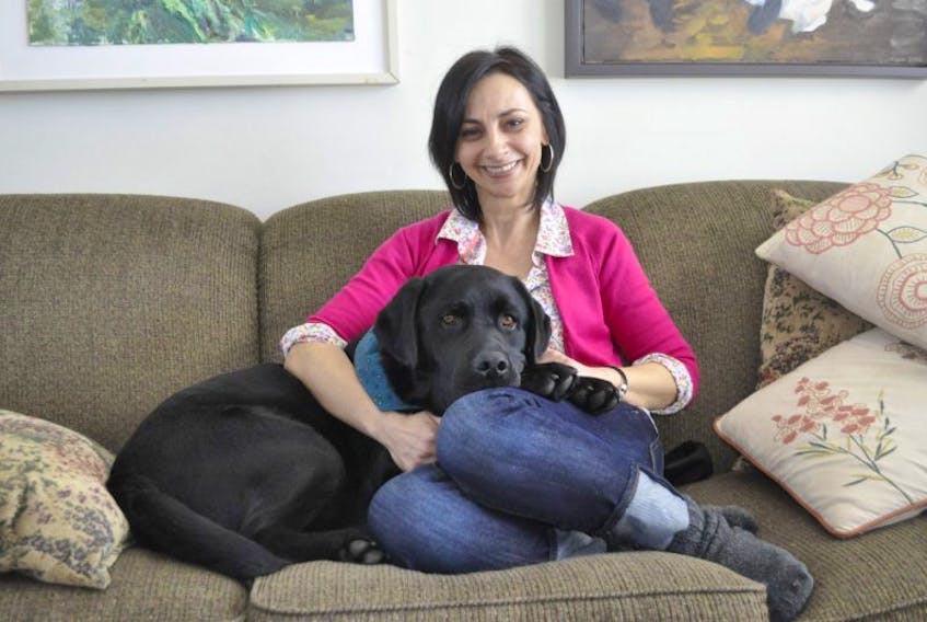 Julia A. Wassef and her therapy dog Figgy Duff relax at home in Avonport