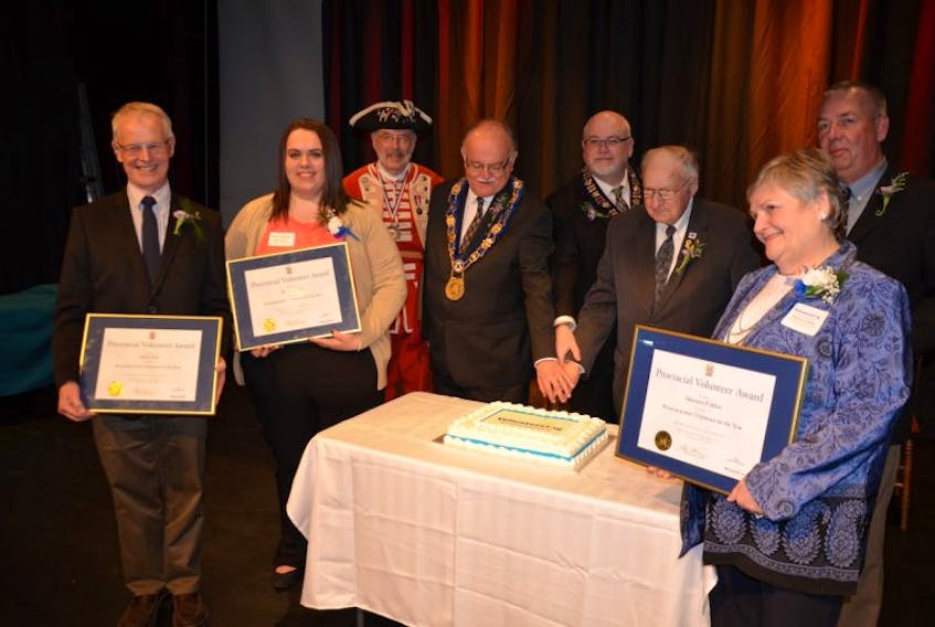 Four provincial volunteers were recognized at the awards gala Wednesday evening in Annapolis Royal. They took part in the official cutting of the volunteer cake after the ceremonies. They are seen holding their certificates. From left are: Harry Jost, Rianna Lewis, Town Crier Peter Davies, Middleton Mayor Calvin Eddy, Annapolis Royal Mayor Michael Tompkins, Annapolis County Warden Reg Ritchie, Maureen Publow, and Brad Reid.