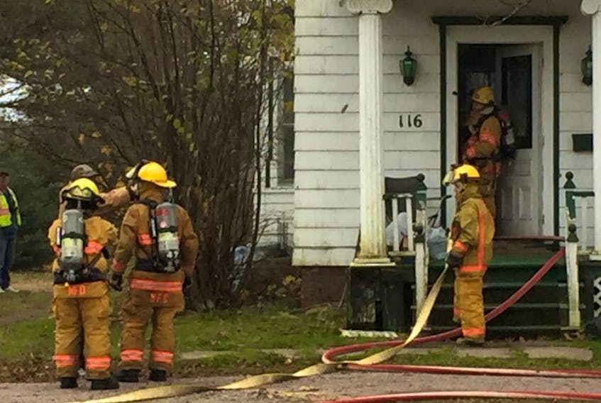 Middleton firefighters are on the scene of a house fire on Highway 1 just west of Middleton. Smoke was seen coming through a window on the top floor. Firefighters wearing masks and air packs dragged hoses into the house as seen here.