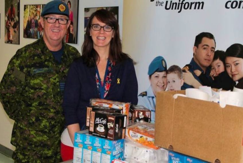 Honorary Col. Dan Hennessey from 14 CES in Bridgewater and Michelle Darrel, deployment services co-ordinator of the Greenwood Military Family Resource Centre pack boxes filled with treats for members deployed overseas.