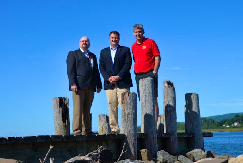 Annapolis Royal Mayor Michael Tompkins, West Nova MP Colin Fraser, and Nova Scotia Premier Stephen McNeil on Annapolis Royal’s boardwalk Friday after a funding announcement at Market Square. Adjacent to where they are standing, a site is being developed on which a boat will be built that will include participation by tourists and others visiting the town. The project is part of a $657,078 waterfront development that has received federal and provincial funding.