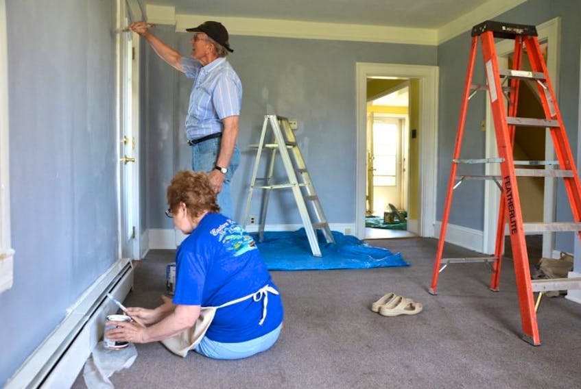 Emily Jenkins, Brian Harvey, Ron Habinski, and Jill Cox are a few of the volunteers getting the house ready for an Iraqi family in Middleton..