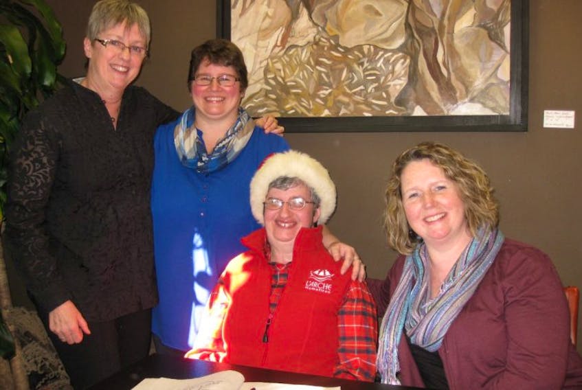 It’s going to be a bright Christmas for Machelle Hubley, third from left, and her family. From left are L’Arche Homefires director Ingrid Blais, and Hubley’s sisters, Candace Bird and Coral Rafuse.