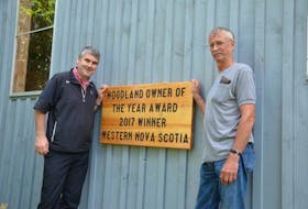 David Bent, right, has a big sign on the end of his barn proclaiming him Nova Scotia’s Western Region Woodlot Owner of the Year winner for 2017. Nova Scotia Premier Stephen McNeil dropped by Sept. 23 to congratulate him.