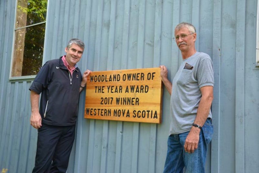 David Bent, right, has a big sign on the end of his barn proclaiming him Nova Scotia’s Western Region Woodlot Owner of the Year winner for 2017. Nova Scotia Premier Stephen McNeil dropped by Sept. 23 to congratulate him.
