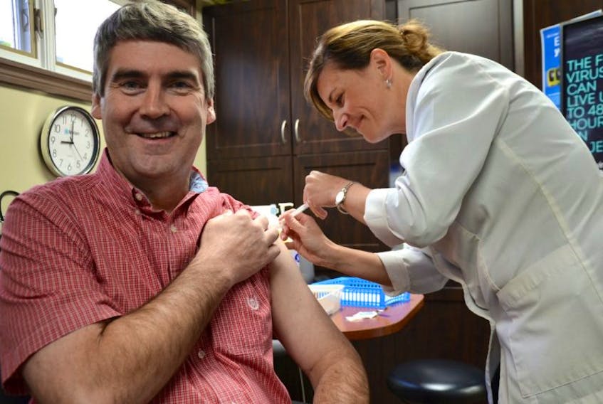 Krista McClair administers Premier Stephen McNeil his annual flu shot at Hutchins Pharmacy in Annapolis Royal this morning. The Guardian pharmacist can administer flu shots for the general public, free of charge, during open hours 9 a.m. to 8 p.m. throughout the week, until 5 p.m. on Saturdays, and from noon to 5 p.m. on Sundays. Bring your health card.