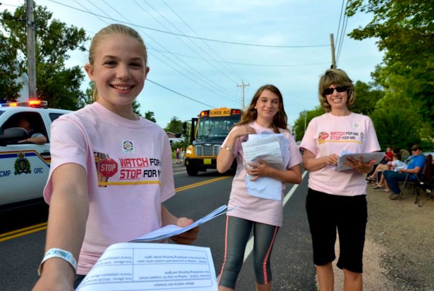 Students handed out information on school bus safety Aug. 14 at the Annapolis Valley Exhibition parade in Lawrencetown. ‘Watch For Me, Stop For Me’ is the campaign theme. Automatically slowing down when you see a school bus, or when you enter a school zone, is the first step.
