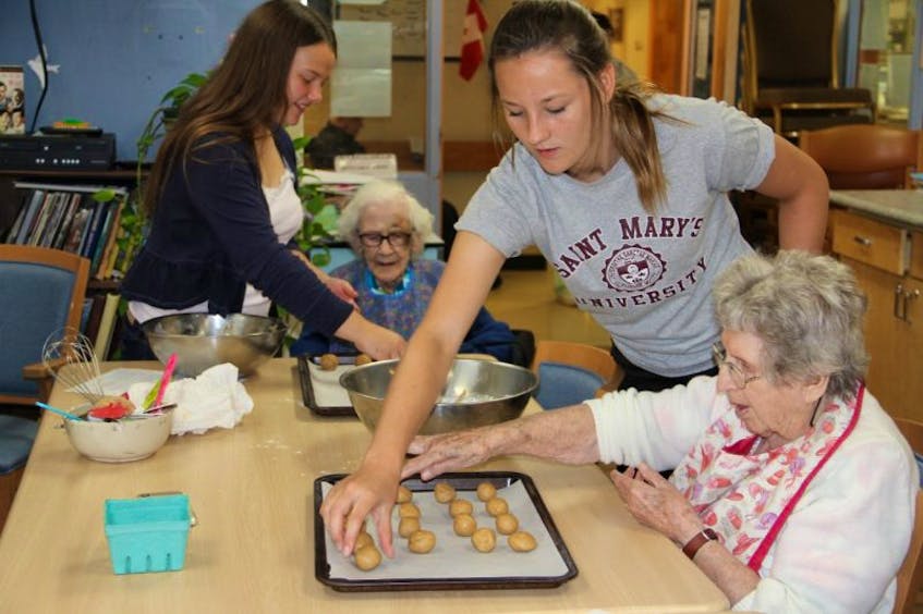 Annika Tibbutt and Haley Saunders were busy making cookies with Phyllis and Elaine last week.