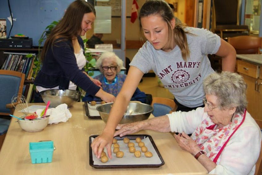 Annika Tibbutt and Haley Saunders were busy making cookies with Phyllis and Elaine last week.