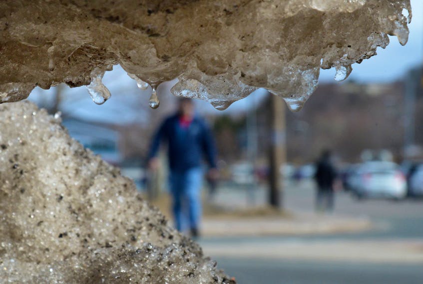 Drops of water hang on the underside of a small ice shelf as people walk on Lake Avenue Thursday afternoon. Warm temperatures gave most of the province a taste of spring the past few days but that feeling will probably end Saturday with heavy rain and snow predicted.

Keith Gosse/The Telegram