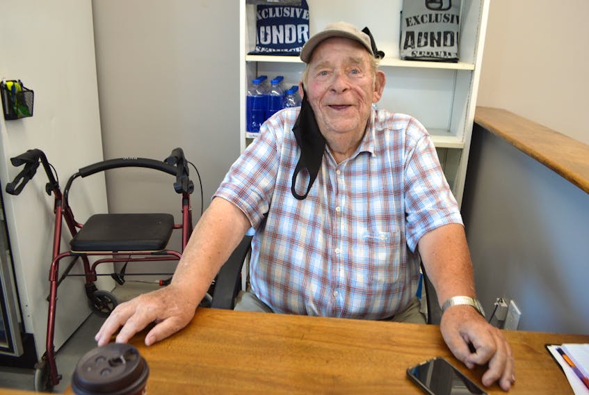 Lawrence Somers, 87, founder of Ashby Laundromat in Sydney, is back in his chair at the door of the business after the building was rebuilt following a devastating fire five years ago. Although Somers sold his business to his daughter Janet Somers about 15 years ago, to the delight of their longtime customers, he never left. Sharon Montgomery-Dupe/Cape Breton Post 