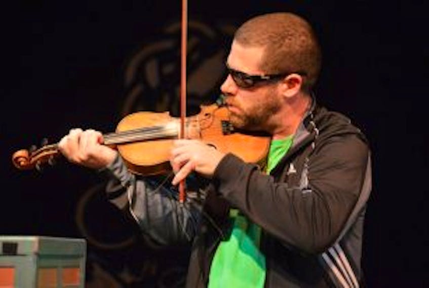 ['In this file photo, fiddler Ashley MacIsaac is shown performing while in Cape Breton in 2015.']