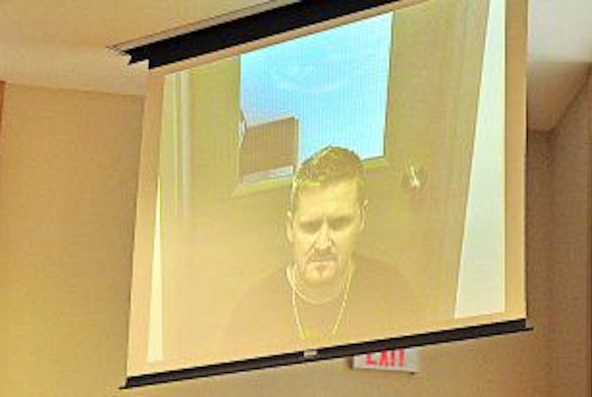 ['Gary Kean/The Western Star<br />Ashley Shannon Park of Corner Brook appeared via video from Her Majesty’s Penitentiary in St. John’s for his provincial court appearance in Corner Brook on armed robbery-related charges Tuesday.']