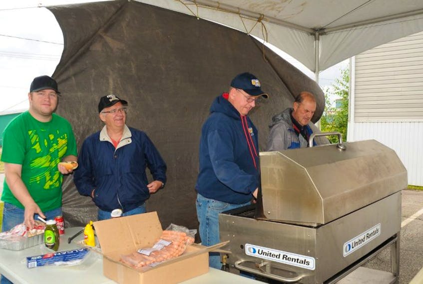 Labour council volunteers help with the grilling of lots of free hot dogs for everybody who dropped by.