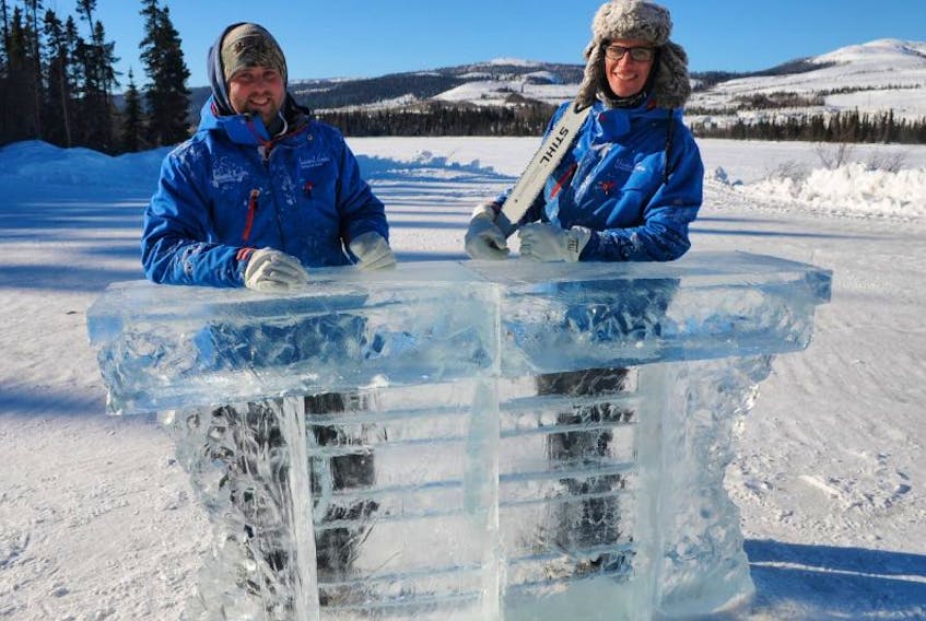 Michäel Belley(l) Nicolas Godon (r) . Instructors at snow sculpture workshop in Labrador west pose in front of the beautiful ice bar they carved in front of Tanya Lake, Labrador City.