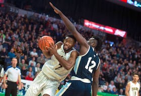Dalhousie Tigers forward Jordan Wilson drives to the hoop against St. Francis Xavier  X-Men forward Azaro Roker during the  AUS men’s basketball championships game at the Scotiabank Centre on Sunday, March 1, 2020.