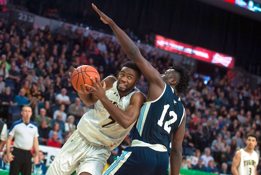 Dalhousie Tigers forward Jordan Wilson drives to the hoop against St. Francis Xavier  X-Men forward Azaro Roker during the  AUS men’s basketball championships game at the Scotiabank Centre on Sunday, March 1, 2020.