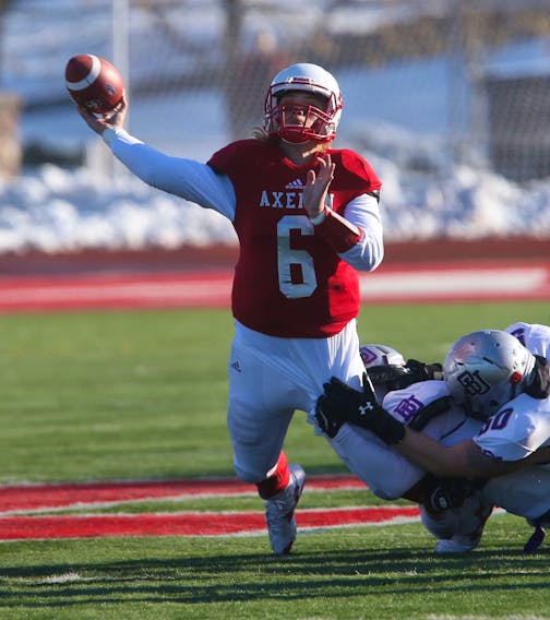 Acadia Axemen quarterback Hunter Guenard evades a tackle by the Bishop's Gaiters during the 2019 Loney Bowl conference championship in Wolfville last Nov. 9.   TIM KROCHAK / The Chronicle Herald 
