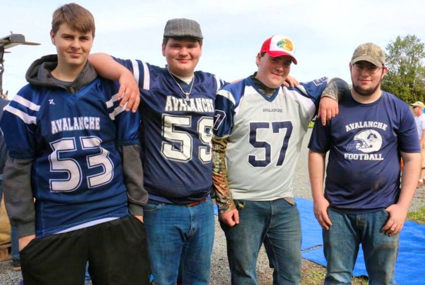 <p>Avon View football players, from left, Blake O'Brien, Mackenzie Benedict, Dawson Lake, and Eric Harvey volunteered at the pumpkin weigh off held at the Dill Farm recently. The team has been busy fundraising for a scoreboard.</p>