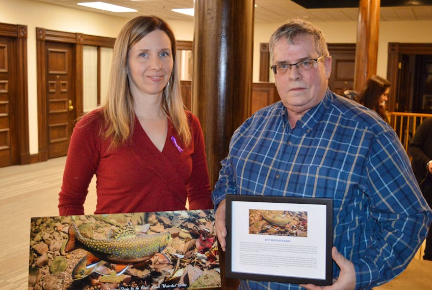 Norman Dewar, co-ordinator with the Ellen’s Creek Watershed Group in Charlottetown, presents Ramona Doyle, the city’s sustainability officer, with the Brookie Award Monday night prior to city council’s monthly meeting. DAVE STEWART/THE GUARDIAN