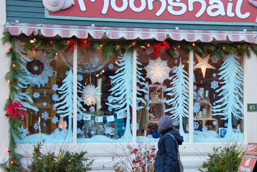 A pedestrian walks past the Moonsnail Soapworks store on Water street in Charlottetown. It won first place in the retail category in the recent Christmas window decorating contest sponsored by Downtown Charlottetown Inc. JIM DAY/THE GUARDIAN
